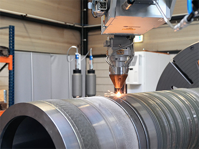 A Hornet Laser cladding machine that is cladding a round tube.