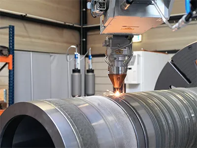 A Hornet Laser cladding machine that is cladding a round tube. 